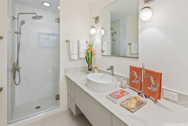 bathroom featuring vanity, tile patterned floors, and walk in shower