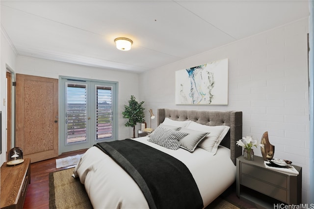 bedroom featuring french doors, dark hardwood / wood-style flooring, and access to outside