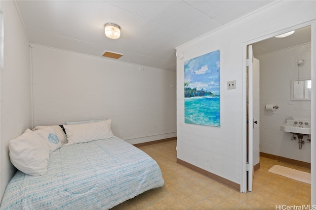 bedroom featuring sink and ensuite bath