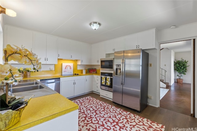 kitchen with white cabinets, sink, dark wood-type flooring, and appliances with stainless steel finishes