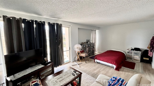 bedroom with a textured ceiling and hardwood / wood-style floors