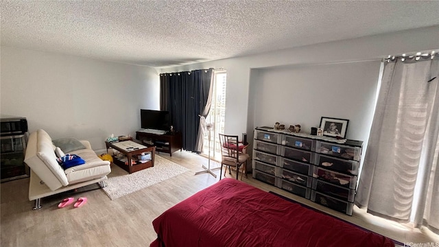 1655 Makaloa St Unit 1009, Honolulu, HI 96814 - bedroom featuring a textured ceiling and wood finished floors