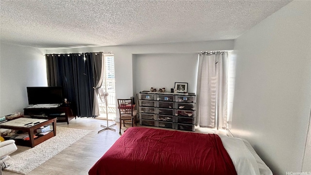 1655 Makaloa St Unit 1009, Honolulu, HI 96814 - bedroom featuring a textured ceiling and wood finished floors