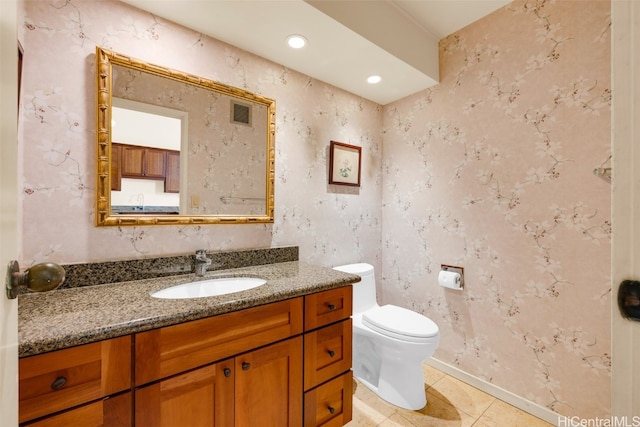 bathroom featuring vanity, toilet, and tile patterned flooring