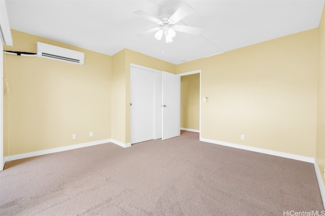 unfurnished bedroom featuring a closet, an AC wall unit, ceiling fan, and carpet flooring