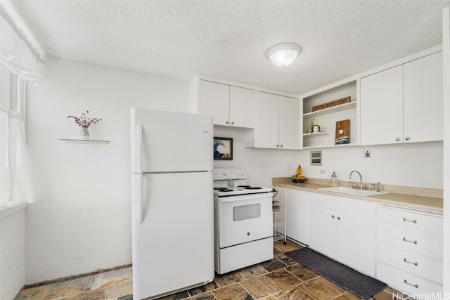 kitchen featuring a textured ceiling, white cabinets, sink, and white appliances