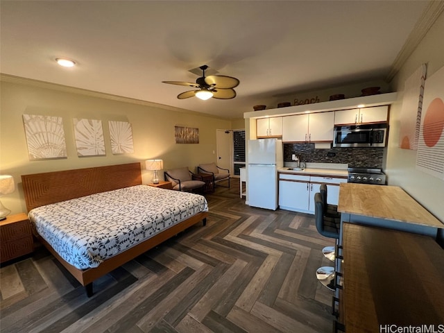 bedroom featuring ornamental molding, dark parquet flooring, sink, and white fridge