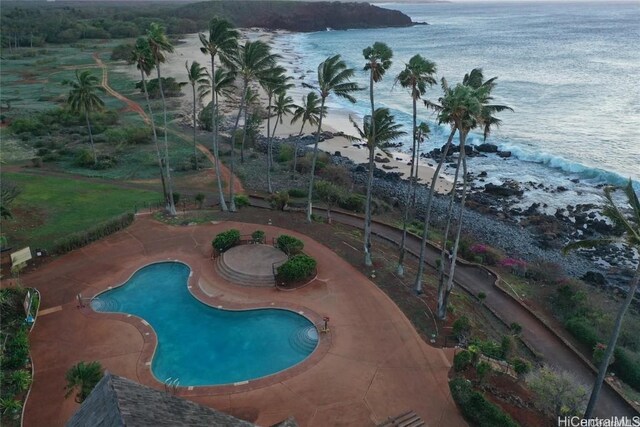 view of pool featuring a patio and a water view