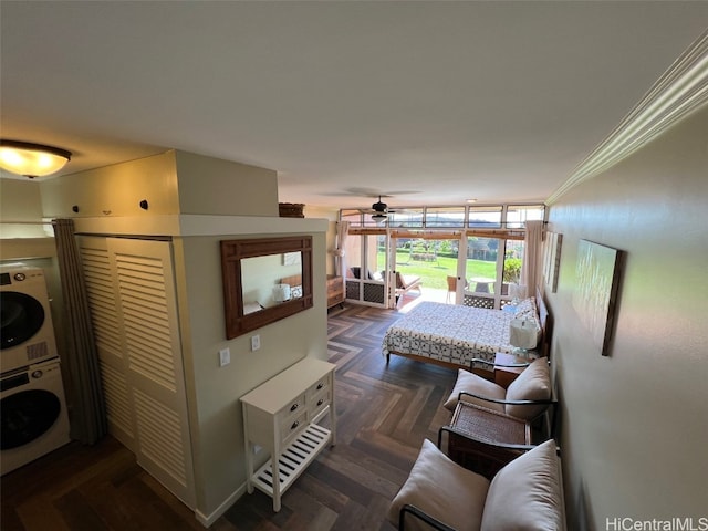 bedroom with stacked washing maching and dryer and dark parquet floors