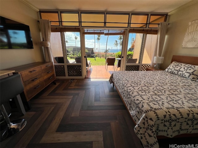 bedroom featuring access to exterior, dark parquet flooring, and ornamental molding