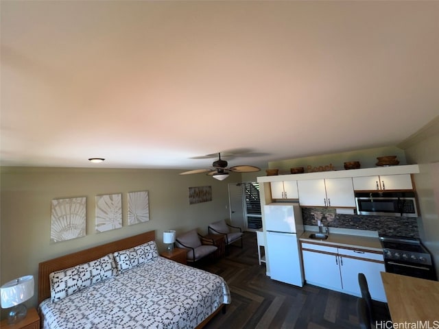 bedroom featuring white refrigerator, dark parquet floors, sink, ceiling fan, and crown molding