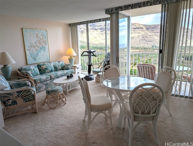 dining space with a textured ceiling and carpet floors