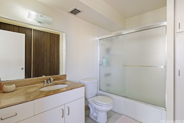 full bathroom with vanity, enclosed tub / shower combo, toilet, and tile patterned flooring