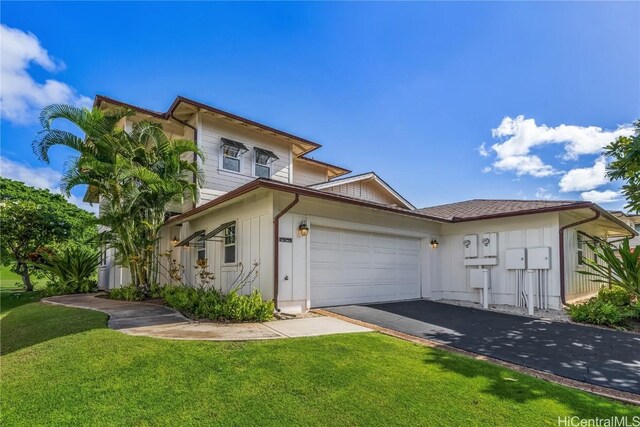 view of front of property with a front lawn and a garage