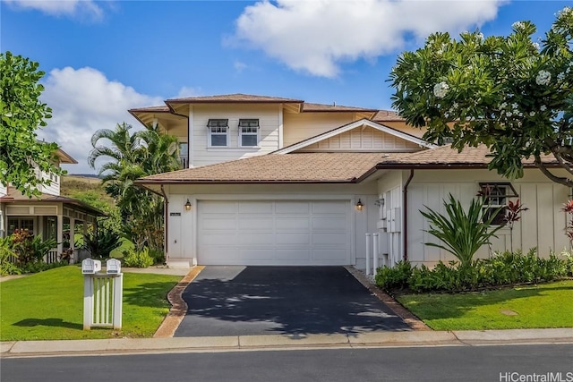 view of front of home with a garage and a front yard