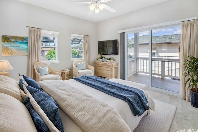 bedroom with access to outside, multiple windows, ceiling fan, and light carpet