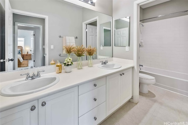 full bathroom with tile patterned flooring, vanity, toilet, and tiled shower / bath combo