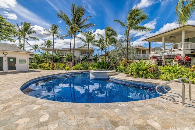 view of swimming pool featuring ceiling fan and a patio area