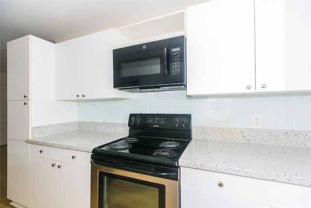 kitchen with white cabinets, tasteful backsplash, black appliances, and light stone counters