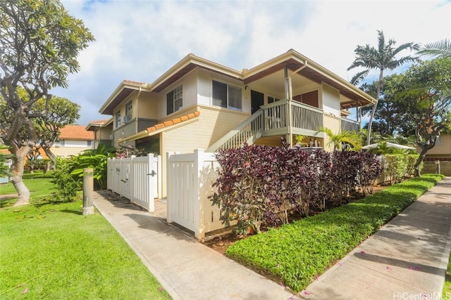 view of property exterior featuring a yard, fence, and a gate