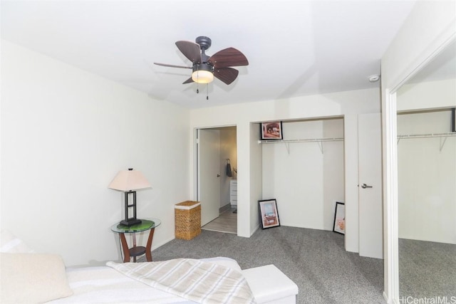 carpeted bedroom with multiple closets and ceiling fan