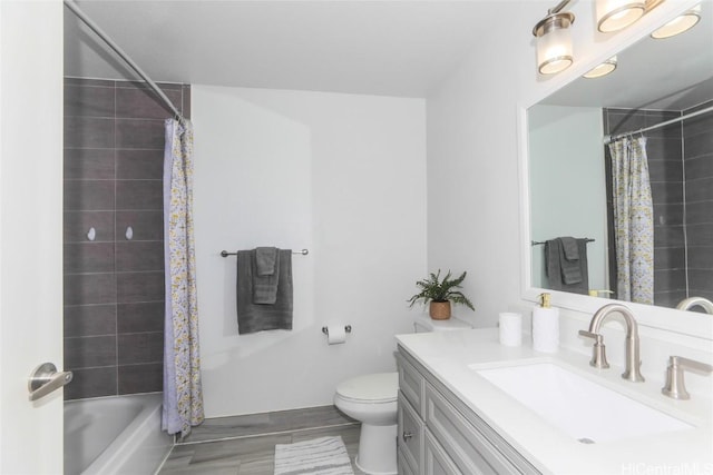 bathroom featuring shower / bath combination with curtain, vanity, and toilet