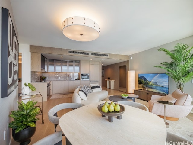 dining space with light hardwood / wood-style floors