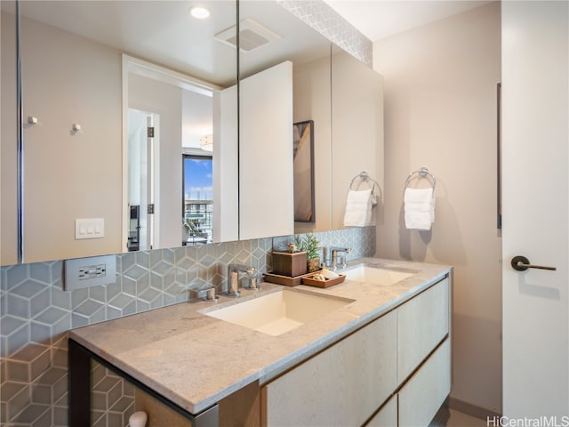 bathroom featuring vanity and backsplash