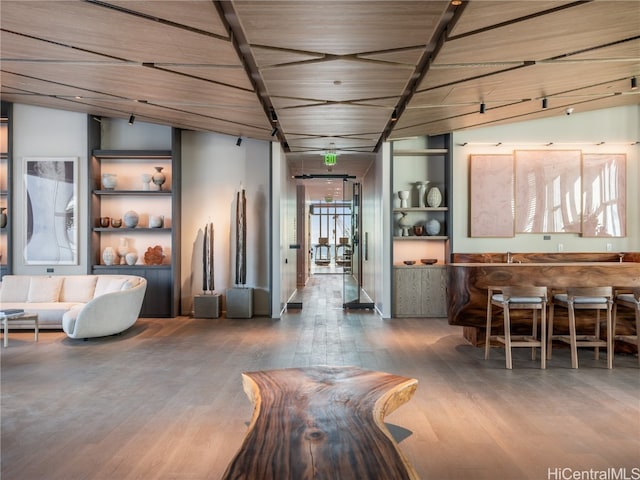 interior space featuring lofted ceiling, wood ceiling, and dark hardwood / wood-style floors