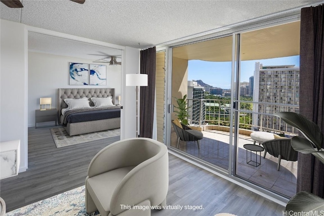 bedroom with floor to ceiling windows, multiple windows, and access to exterior