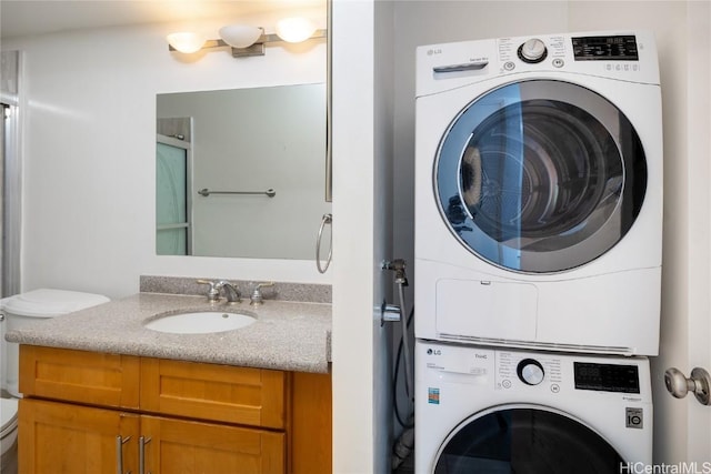 laundry room with sink and stacked washer and clothes dryer