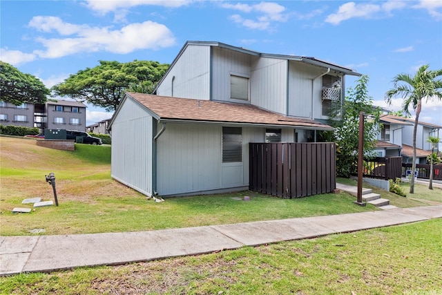 92-988 Panana St Unit 1, Kapolei, HI 96707 - view of side of property with a lawn and roof with shingles