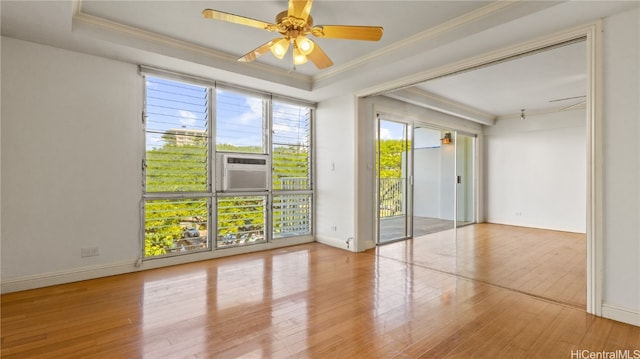 spare room featuring ornamental molding, hardwood / wood-style floors, cooling unit, and ceiling fan