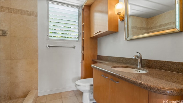 bathroom featuring walk in shower, vanity, toilet, and tile patterned floors