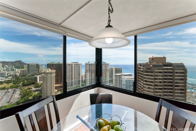 dining area with a water view, expansive windows, and plenty of natural light