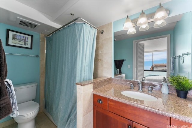 bathroom with vanity, tile patterned floors, toilet, and walk in shower