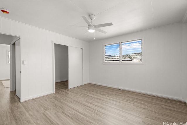 unfurnished bedroom with light hardwood / wood-style floors, ceiling fan, and a closet