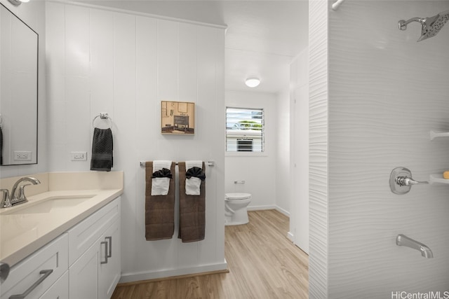 bathroom featuring vanity, hardwood / wood-style flooring, and toilet