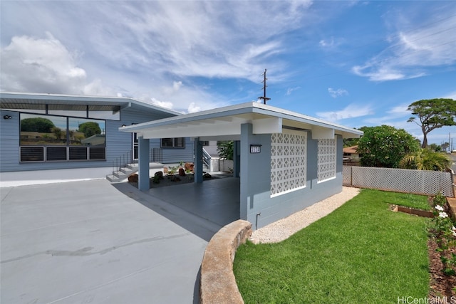 view of side of home with a yard