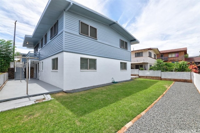 exterior space featuring a lawn and a patio