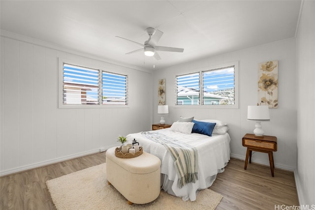 bedroom with ceiling fan and light wood-type flooring