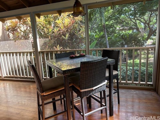 sunroom featuring beamed ceiling