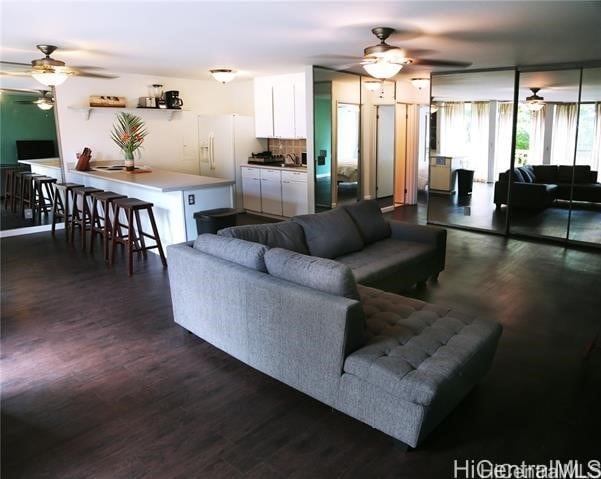 living room with dark wood-type flooring and sink