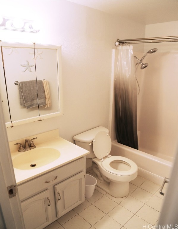 full bathroom featuring vanity, shower / bath combo with shower curtain, toilet, and tile patterned flooring