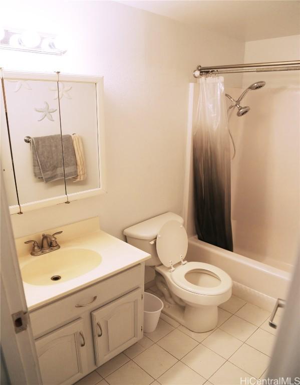 bathroom featuring shower / bath combination with curtain, vanity, toilet, and tile patterned floors