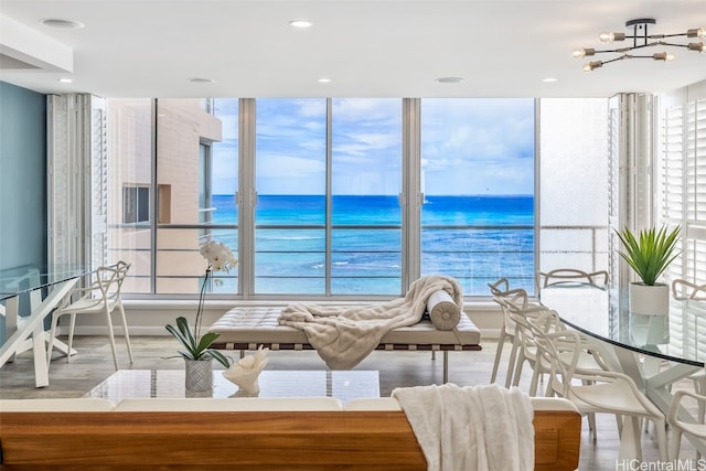 unfurnished dining area with a water view and light wood-style flooring