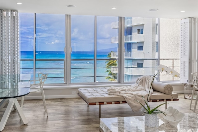 sunroom / solarium with a water view