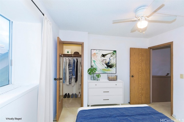 carpeted bedroom featuring a closet and ceiling fan