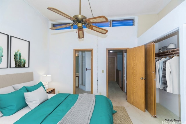 bedroom with light carpet, high vaulted ceiling, a closet, and ceiling fan