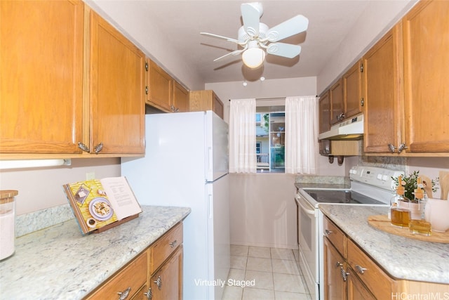 kitchen with light stone countertops, ceiling fan, light tile patterned floors, and white appliances